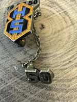 Front view showing BB emblem with 1950 and dangling 50 charm