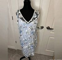 Full front view of embroidered sheath dress on mannequin