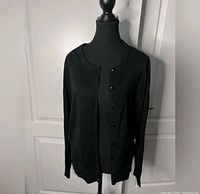 Front view of black cardigan on mannequin