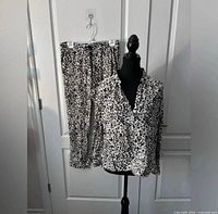 Full view of top on mannequin and matching pants on hanger