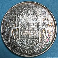 Reverse of 1947 Canada 50¢ coin, coat of arms visible