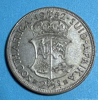Reverse of 1952 South Africa 2½ Shillings coin showing coat of arms, date and denomination