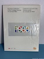 Front cover showing title, bilingual text, multicolour 1983 graphic, sealed wrap