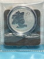 Obverse side of coin in capsule showing denomination and Queen portrait