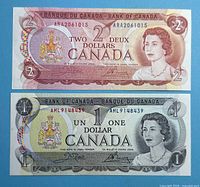 Fronts of 1973 $1 and 1974 $2 Bank of Canada notes showing overall condition and serial numbers