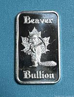 Front of Beaver Bullion 1/10 oz .999 silver bar showing beaver and maple leaf design