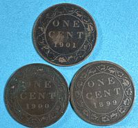 Obverse sides of three Canada one cent coins dated 1901, 1900, 1899 showing wear and corrosion