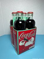 Front view of Coca-Cola 125 Years 4-pack showing two bottles and front panel graphics