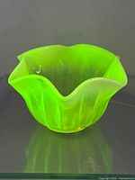Bowl glowing bright green under UV light showing fluorescence