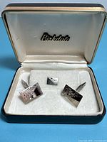 Open Birkdale box showing two cufflinks and matching stud