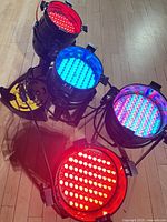 Front view of four LED Par Cans illuminated in red, blue and mixed colours
