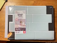 Front view of sealed Smart Tiles Metro Mia package showing tile color and size information