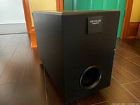 Front view of black Pioneer HTP-100-SW subwoofer showing port and model badge