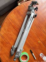 Full view folded Velbon aluminum tripod on table