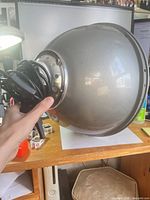 Side view of metal beauty dish with attached cord