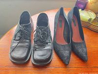 Front view of both pairs: lace-up brogues left, pointed-toe heels right