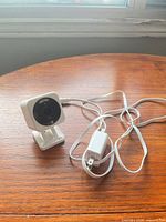 Front view of Wyze Cam v4 with attached USB cable and power adapter