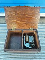 Open music box showing divided interior and mechanism