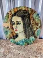 Front view of round ceramic plaque showing painted portrait and color details