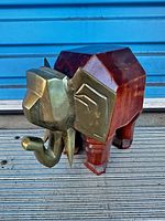 Side view of brass-wood elephant figurine