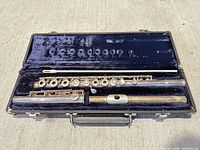 Flute headjoint, body, cleaning rod and case interior