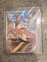 Front view of Fuecoco Gem Pack Exclusive promo card in protective sleeve and top-loader