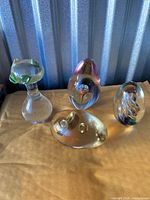 All four glass paperweights grouped