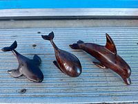 Three ironwood carvings displayed together