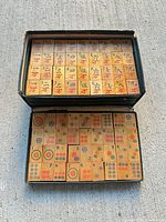 Open box displaying full rows of Mahjong tiles
