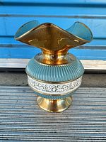 Full view of ceramic vase showing gold luster, aqua ribbed band, white scroll band and flared rim