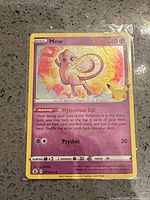 Front of Mew Celebrations Pokémon trading card, showing artwork, stats, set number and holo foil