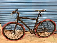 Full side view of black Micargi bike showing frame, wheels, tires, drivetrain and brakes