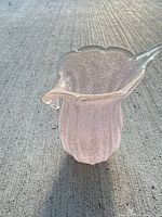 Side view of pink art glass vase showing ruffled rim and bubble pattern