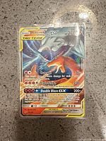 Front of Reshiram & Charizard GX card in sleeve