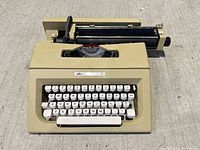 Top view of beige Olivetti Lettera 25 manual typewriter showing full keyboard and carriage