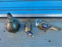 Three bird figurines grouped together