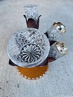 Full view of condiment set showing bowl, shakers, tall holder, and stand