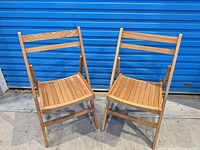 two wooden folding chairs front view