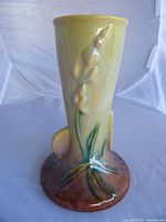 Front view of Roseville Wincraft bud vase showing calla lily decoration and color gradient