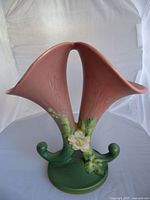 Front view of Roseville double-horn cornucopia vase showing rose motif and full shape