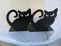 Front view of both black metal cat bookends
