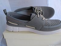 Side view of grey Speedo deck shoe on box showing perforated upper, lace system, white sole