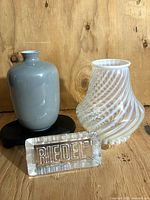 Group shot of grey porcelain vase, opalescent swirl glass vase, Riedel paperweight