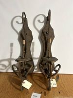Front view of both wrought iron sconces showing overall form and sockets