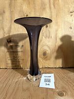 Full view of amethyst trumpet vase standing upright