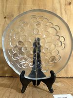 Front view of clear glass bowl showing raised grape motif