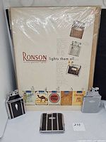 Poster and three Ronson smoking accessories displayed together