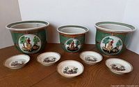 Full set of three planters and five saucers on table