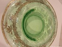 Top view showing pale green uranium glass bowl and gold floral decoration