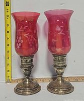 Front view of both candlesticks with tape measure for height reference